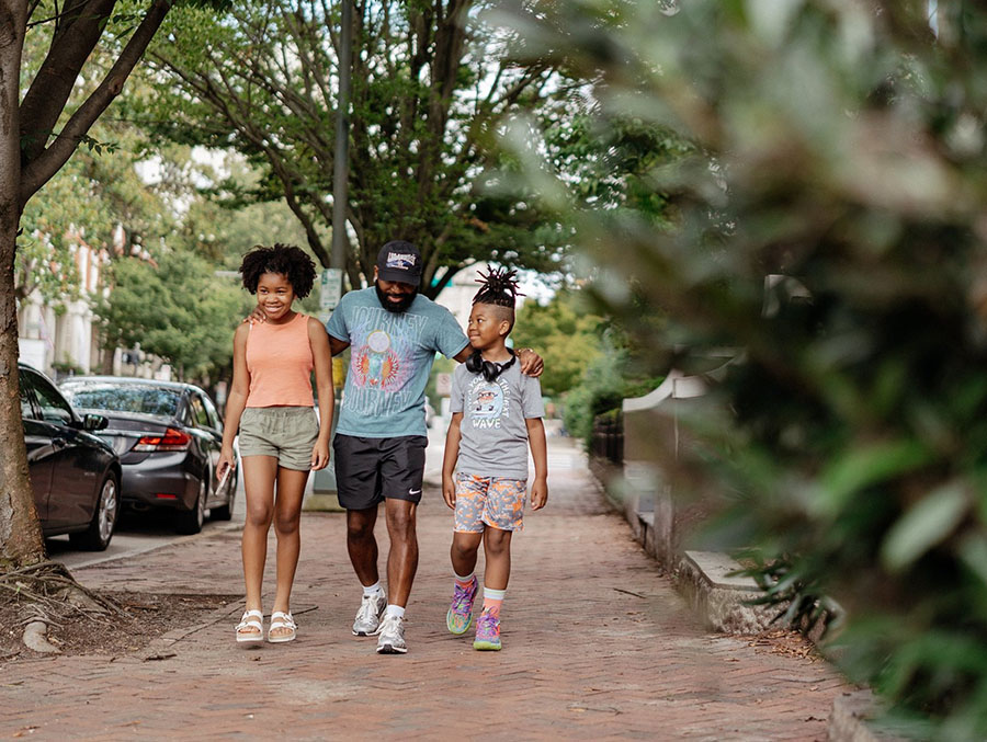 Man walking with children down richmond, va street